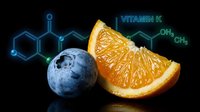 Fresh orange slice and blueberry with glowing vitamin K molecular structure on black background for nutrition education and healthy eating concepts.