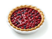 Homemade berry pie with golden crust filled with fresh raspberries and blueberries, served in white ceramic dish on isolated background for bakery, dessert and food design projects.