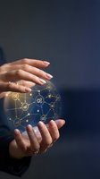 Female hands protecting glowing digital network with connected icons representing business automation and technology solutions on dark background.