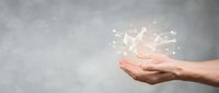 Hand holding glowing origami paper dove with sparkling light particles, symbolizing peace, hope, freedom and new beginnings for spiritual or inspirational design projects.
