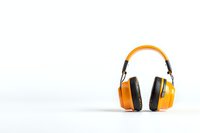 Modern yellow protective headphones isolated on white background with copy space for text or design. Professional hearing protection equipment.