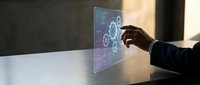 Businessman touching transparent digital interface with gear icons and data visualization, representing technology innovation and futuristic business solutions.