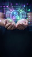 Hands holding glowing holographic user profile icon with shield protection symbol in digital environment for cybersecurity and data privacy concepts.