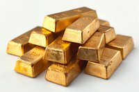 Stack of shiny gold bars arranged on white background showing wealth, luxury and financial investment concept. Isolated bullion ingots with metallic texture.