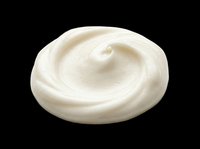 Creamy white cosmetic lotion or moisturizer swirl isolated on transparent background, ready for skincare product design, packaging, and print-on-demand applications.