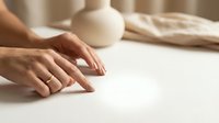 Woman hands kneading dough on white surface with rolling pin and flour for homemade bread baking in kitchen cooking preparation.