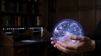 Young adult male hand holding glowing neural network sphere in dark office environment with computer setup, representing artificial intelligence, technology innovation, and digital transformation concepts.