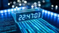 Futuristic digital clock displaying time on glowing blue circuit board with bokeh lights background for technology and time management concepts.