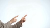 Two hands pointing fingers in same direction against white background for business presentation and teamwork concepts.