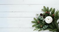 Festive evergreen arrangement with white candle, pinecones, and eucalyptus on wooden surface, perfect for holiday decorating and seasonal marketing materials.