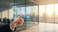 Businessman hand touching futuristic holographic interface with rocket launch icons in modern office space with glass walls and city skyline at sunset.