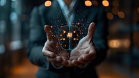 Magical glowing butterfly emerges from cupped hands against dark background with bokeh lights, creating mystical atmosphere and sense of wonder.