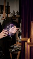 Person with dark nail polish holding glowing compass rose with purple neon light in mystical interior setting. Occult divination concept.
