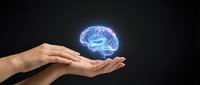 Human hands presenting glowing digital brain hologram on dark background for artificial intelligence and neuroscience concepts.