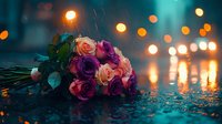 Romantic bouquet of pink and purple roses lying on wet pavement during rainy evening with glowing bokeh lights in background.