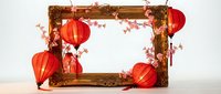 Ornate wooden frame decorated with red paper lanterns and cherry blossom branches for festive celebrations and cultural events.