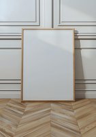 Wall with classic molding, on chevron parquet floor. Natural light casting soft shadows creates elegant interior setting.