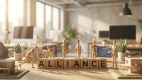 Young diverse professionals in business attire standing around wooden blocks spelling alliance in modern office workspace with plants and windows, representing teamwork and corporate partnership.