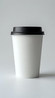 White disposable coffee cup with black lid isolated on gray background for branding mockup and cafe business design projects.