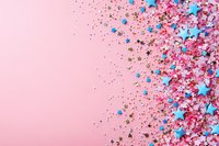 Festive border design with blue star sprinkles and pink glitter scattered on pastel pink background, creating celebratory party decoration layout with copy space.