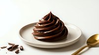 Elegant chocolate soft serve ice cream swirl on white plate with cocoa beans and golden spoon on cream background for dessert menu design.