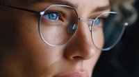 Close-up portrait of young Caucasian woman wearing stylish eyeglasses with blue eyes and natural makeup for vision care and professional lifestyle concepts.