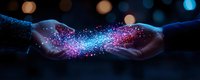 Magical glowing particles flowing between two hands in darkness, creating ethereal connection with pink and blue sparkles against black background with bokeh lights.