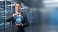 Middle-aged Caucasian businessman in suit protecting digital security lock icon with hands in modern data center server room for cybersecurity concepts.