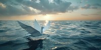 Elegant white paper origami crane floating on ocean waves at sunset, symbolizing hope and serenity. Dramatic sky with sunbeams breaking through clouds creates peaceful maritime scene.