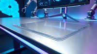 Futuristic laboratory with robotic arms and glass surface in neon blue purple lighting for scientific research and technology concepts.