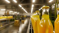 Orange juice bottles on industrial conveyor belt in beverage production facility with automated manufacturing line and fluorescent lighting in background.