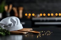 White chef hat on wooden cutting board with rosemary sprig and blurred bokeh lights creating cozy restaurant atmosphere, dark moody background for culinary concepts.