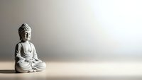 Serene Buddha statue in meditation pose on wooden surface against neutral background for mindfulness and spiritual wellness concepts.