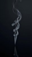 Elegant white smoke swirls gracefully upward against dark background creating mystical atmospheric effect for creative design projects.