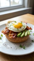 Gourmet avocado toast topped with crispy bacon and fried egg on seeded bread, garnished with fresh herbs on white plate for breakfast menu design.