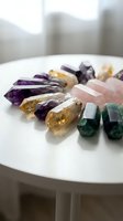 Collection of colorful healing crystals and gemstones arranged on white surface for meditation, spiritual wellness and energy healing practices.