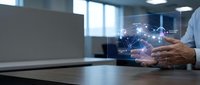 Businessman using tablet with holographic network connections in modern office environment for digital transformation and connectivity solutions.