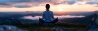Young Asian woman meditating in lotus position on mountain summit at sunrise, panoramic view with misty valleys and dramatic pink clouds.