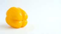 Bright yellow bell pepper isolated on white background, ready for culinary, food, and design projects.