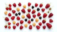 Fresh mixed berries collection with strawberries, raspberries and blackberries arranged on white background for healthy eating and nutrition concepts.
