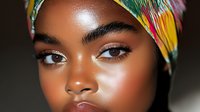 Young African woman with colorful traditional headwrap and natural makeup showcasing cultural beauty and style for fashion and lifestyle content.