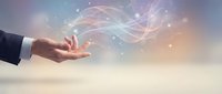 Businessman hand releasing glowing light particles and digital waves, representing innovation, technology transfer, and creative business solutions for corporate projects.