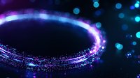 Glowing cosmic ring with sparkling particles and blue bokeh effects on dark background creates magical atmosphere for mystical designs.