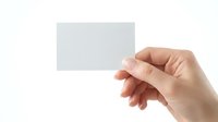 Hand holding blank white business card or paper isolated on white background, ready for custom design and branding.