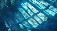 Ethereal underwater light rays streaming through window blinds create dramatic shadows and reflections in blue tones, giving mystical aquatic atmosphere.