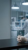 Scientist using futuristic holographic interface technology in modern laboratory with digital data visualization and molecular structures display.
