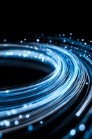 Glowing blue fiber optic cables with light particles flowing in curved lines against dark background, representing high-speed data transmission, internet connectivity, and modern technology infrastructure.