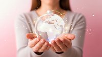 Young woman holding glowing digital earth globe with network connections in cupped hands representing global technology and environmental awareness.