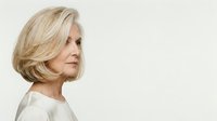 Mature woman with blonde layered hair in profile view against white background, suitable for healthcare, wellness, and lifestyle marketing materials.