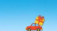 Red toy car carrying oversized yellow gift box with red ribbon on roof against clear blue sky background, isolated for holiday greeting cards and festive designs.